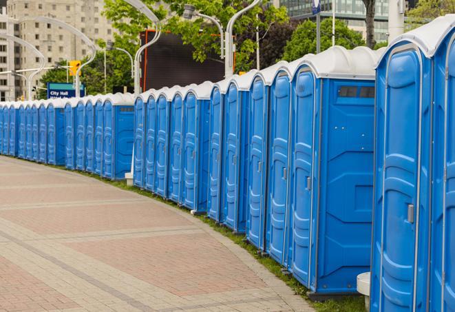 a line of portable restrooms at a sporting event, providing athletes and spectators with clean and accessible facilities in Taylor, MI